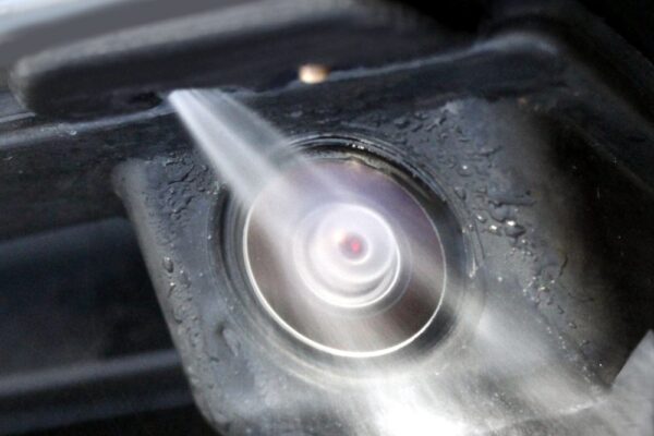 Pressurized jet cleans automotive sensors and cameras