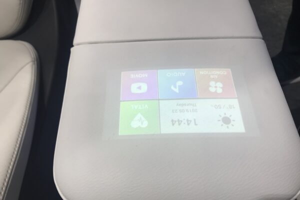 Car controls display shines through upholstery